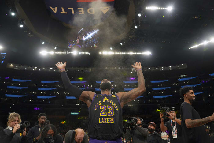 Los Angeles Lakers forward LeBron James throws chalk into the air before his team’s game against the New York Knicks at Crypto.com Arena.